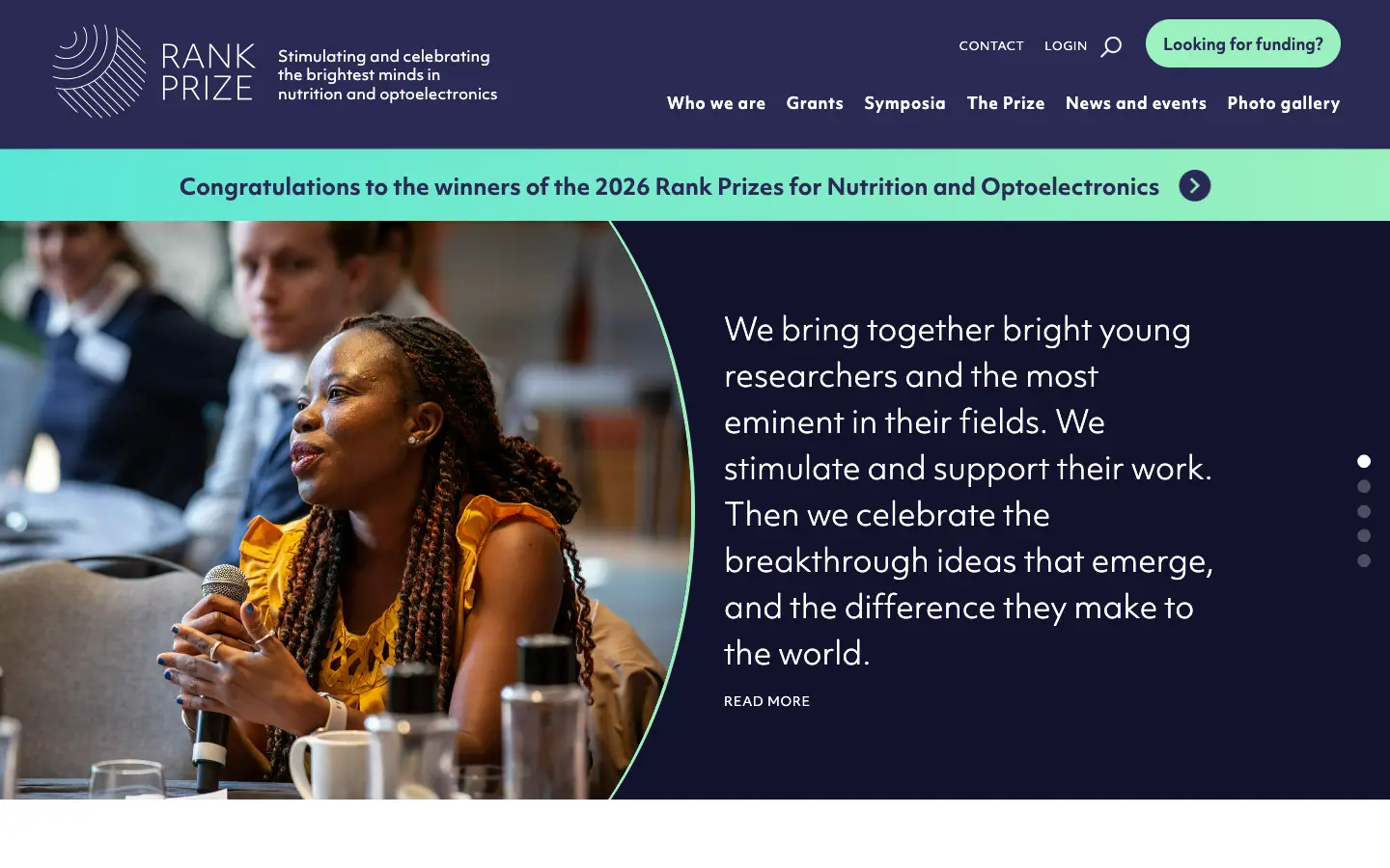 The live Rank Prize homepage: a navy header with the line-drawn logo, a mint banner congratulating the 2026 prize winners, and a curved photo of a researcher speaking at a symposium.